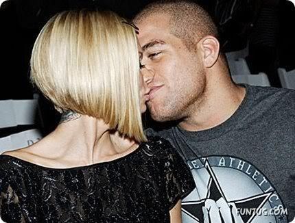 Adult film actress Jenna Jameson, left, kisses her boyfriend, athlete Tito 